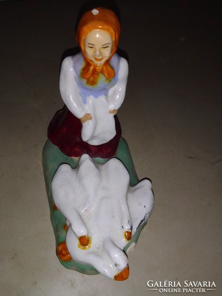 A little girl driving a goose