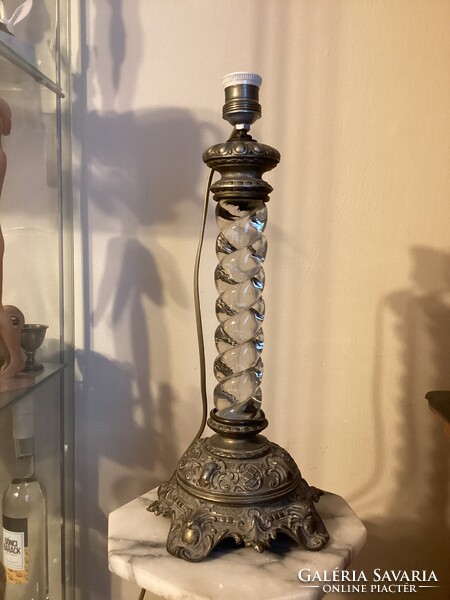 Screwed glass column lamp with embossed metal base.