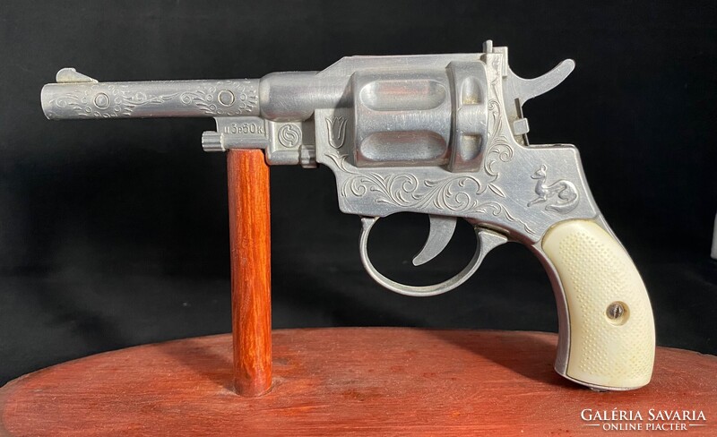 Rose-Propelled Retro Toy Pistol from the 70s on Wooden Stand