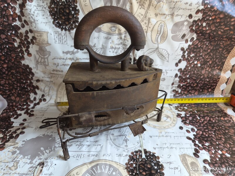 Antique coal-fired cast iron iron with lion head opener and stand