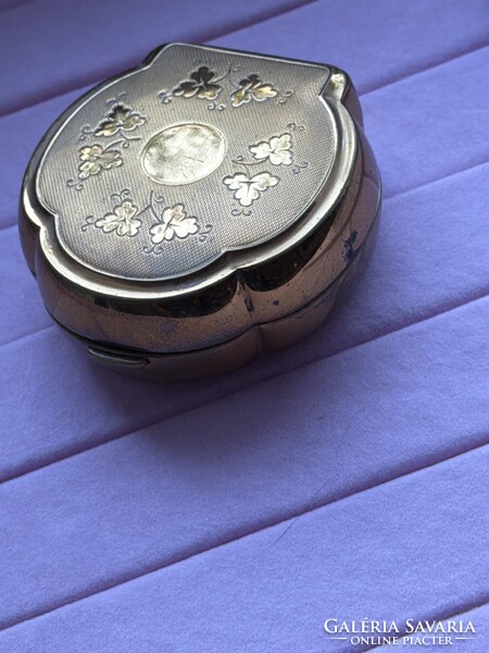 Vintage metal jewelry holder with a unique shape, secure closure
